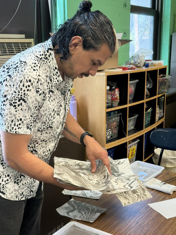 Local Artist hold their creation up